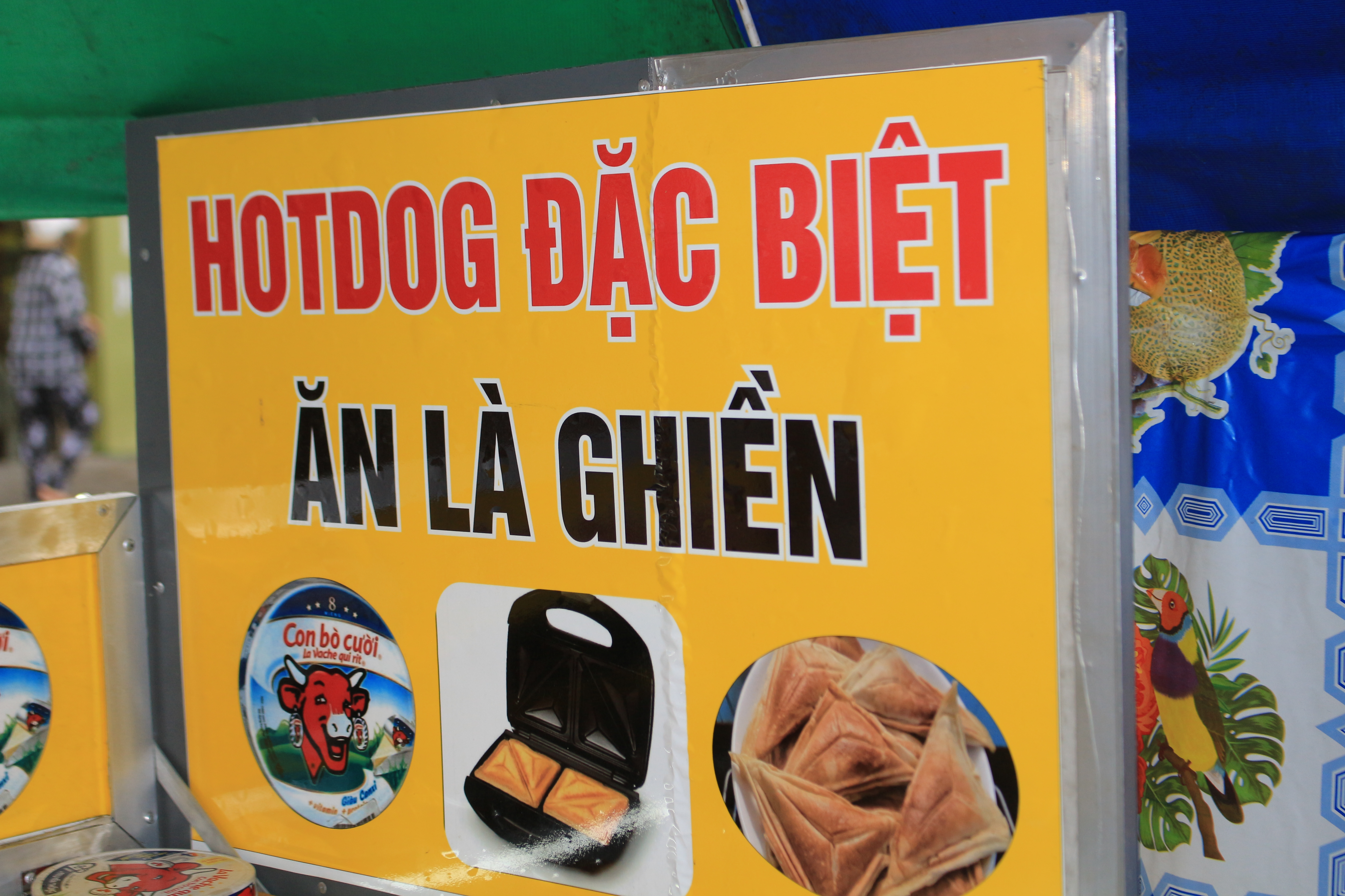 <em>A sign reads 'Special hot dog - Try and get addicted' at a street stall in Go Vap District, Ho Chi Minh City. Photo: R</em>ay Kuschert / Tuoi Tre News