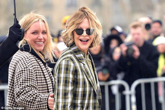 The Hollywood sensation, 62, exuded chic in a checked blazer and khaki shirt, teamed with high-waist smart black trousers