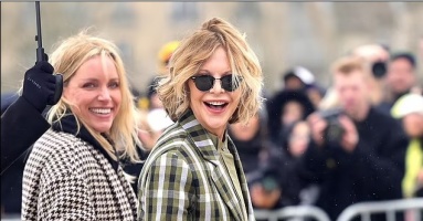 Meg Ryan, 62, shows off her smooth complexion as she steps out in a chic checked blazer and khaki shirt at the Loewe catwalk show during Paris Fashion Week